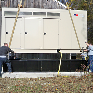 Larger generators are placed with help of a full crane crew